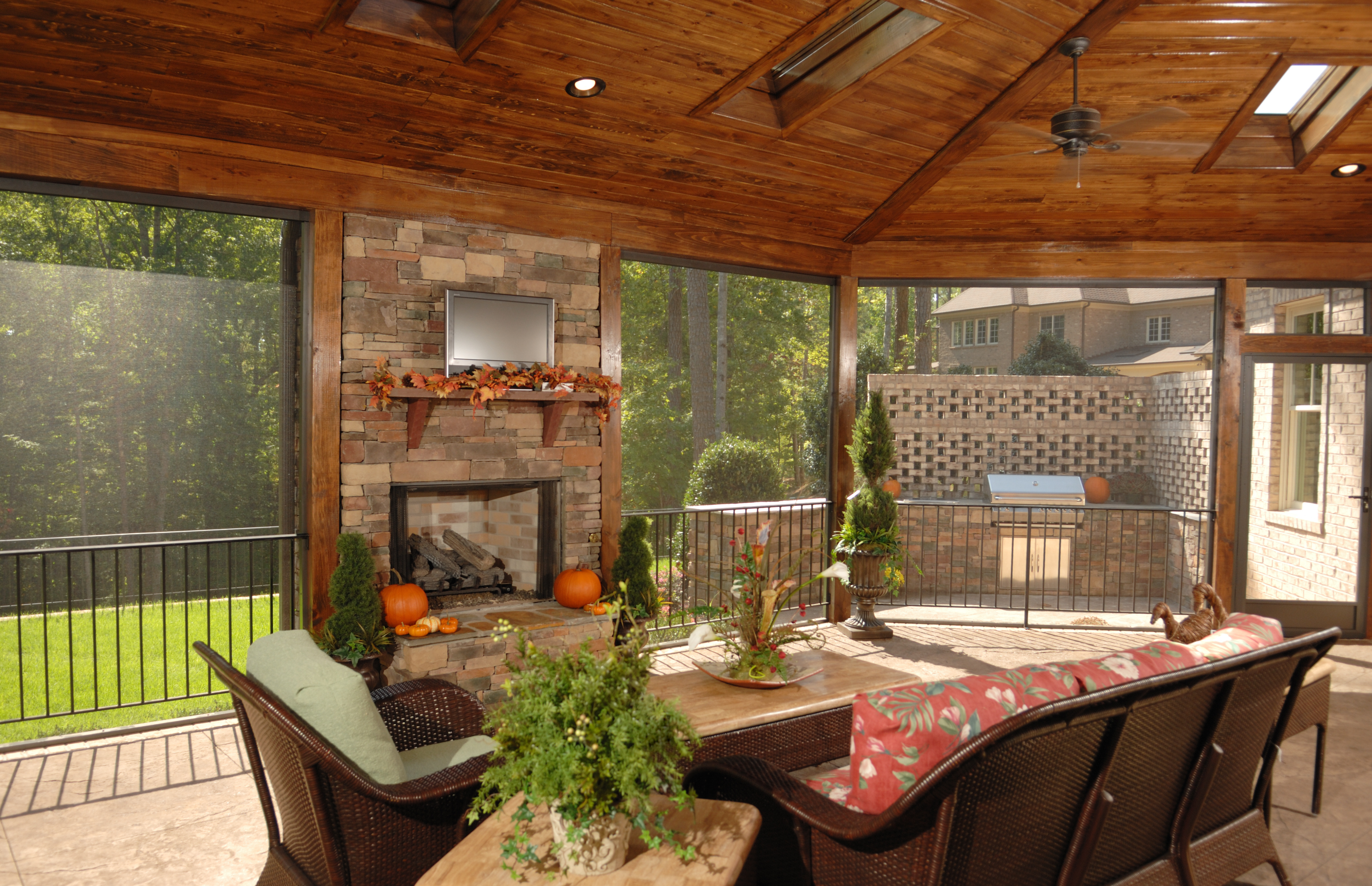 This screened-in patio uses skylights to let in natural lighting and create a warm and welcoming space.