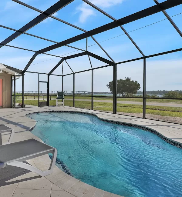 this beautiful, high-quality aluminum pool enclosure overlooks the marshy intercoastal waterway in jacksonville, FL.