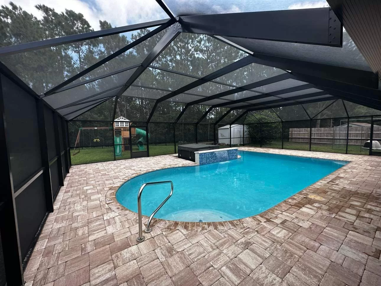 A beautiful pool cage was built for this client right in their backyard in Jacksonville, FL.